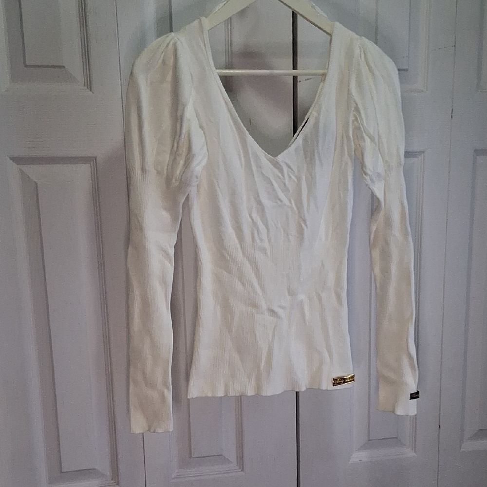 Baby Blue Elegant White V-Neck Sweater. Form Fitting , V-neck And Puff Shoulder.